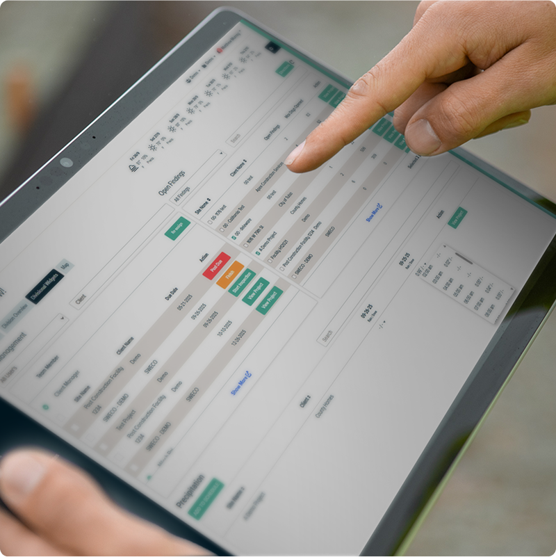 Person using tablet showing software with tables and highlights.